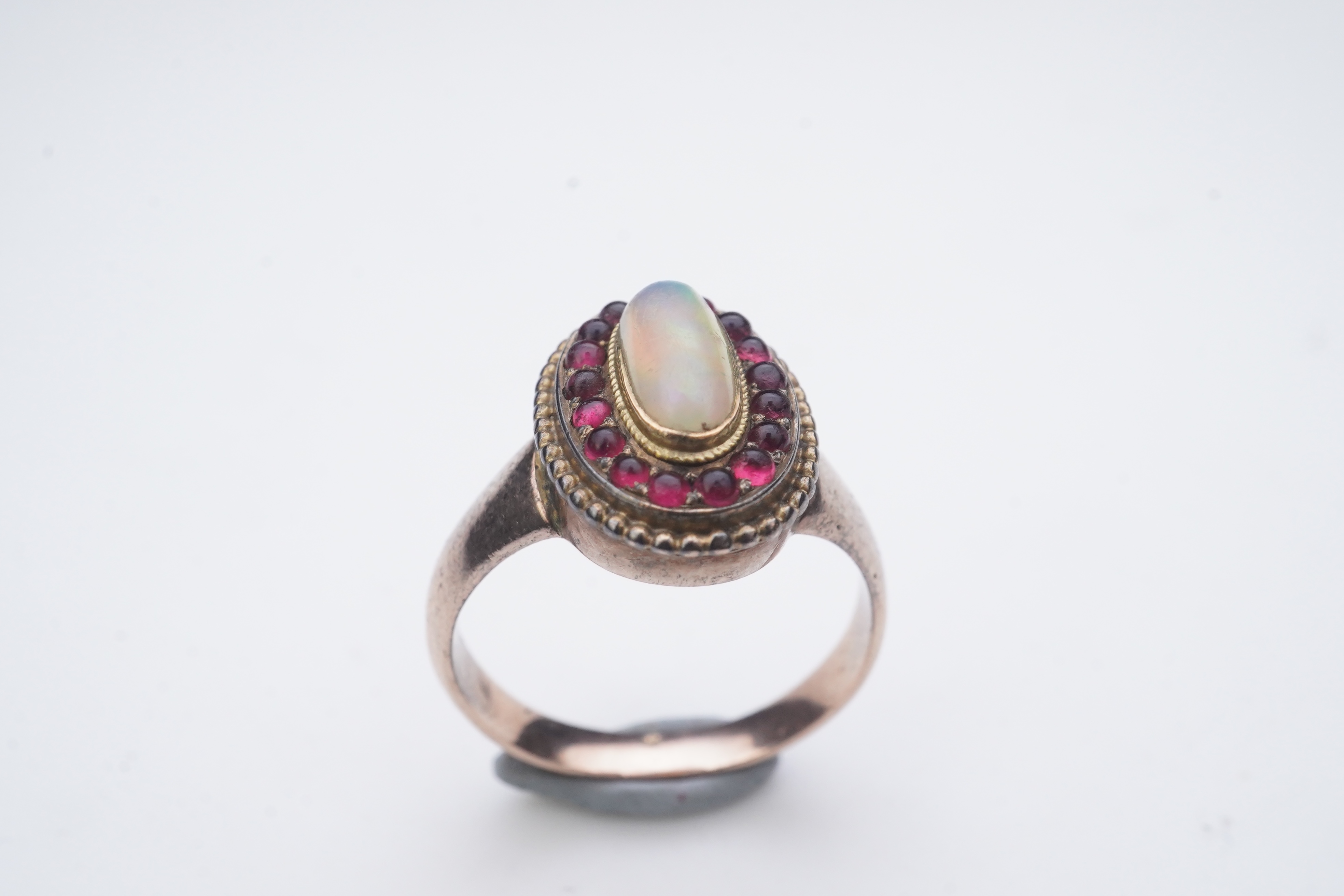 An opal and garnet ring